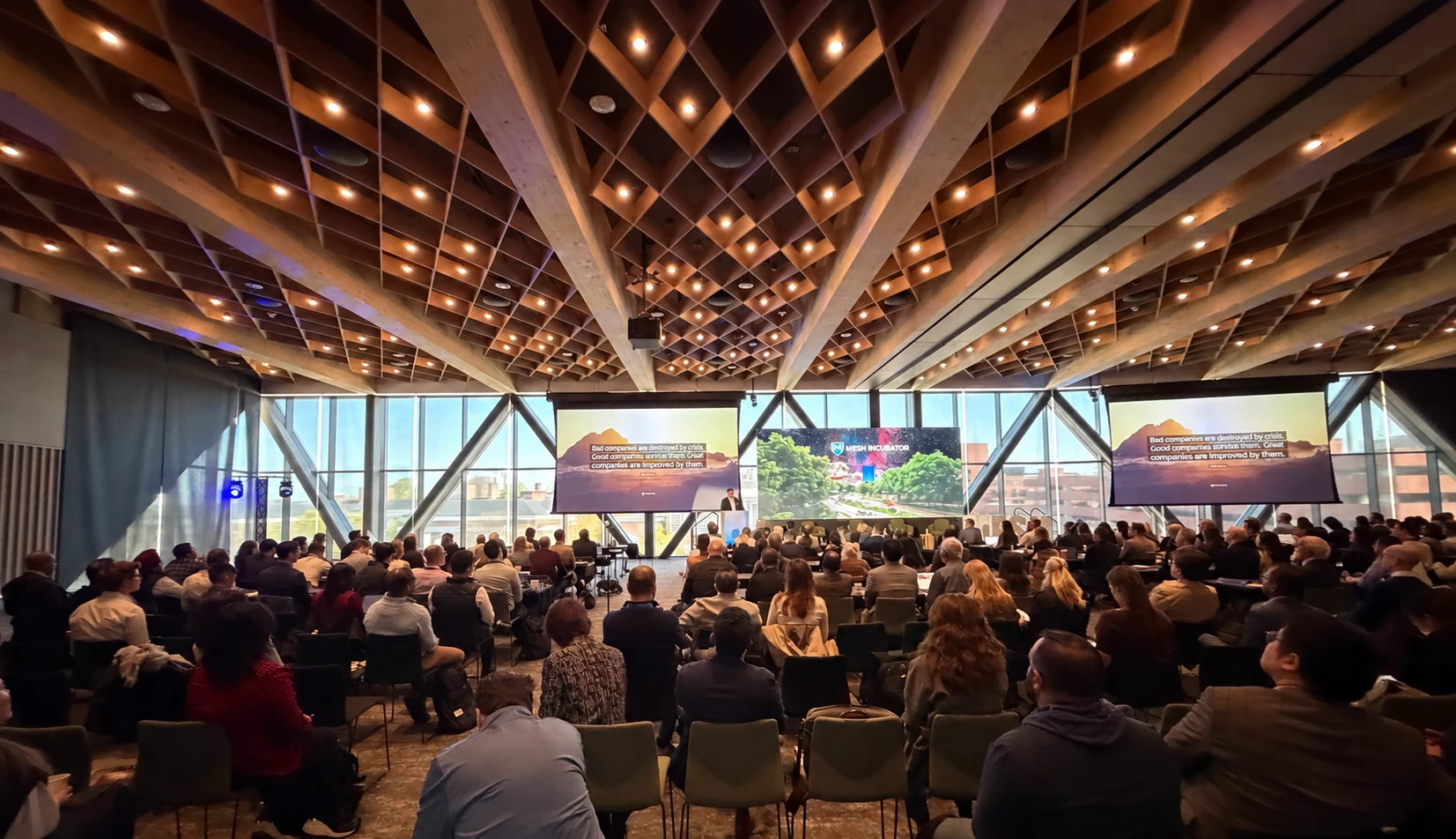 An audience attending a MESH Core course in a large conference hall.
